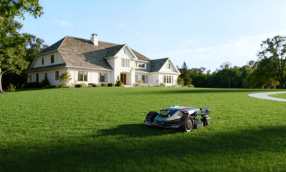 Sunseeker X9 Plus mowing a large lawn in front of a house