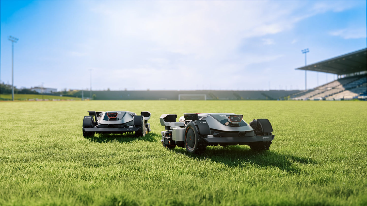 Two Sunseeker X9 Plus mowers on a sports field, showing the scale of area covered