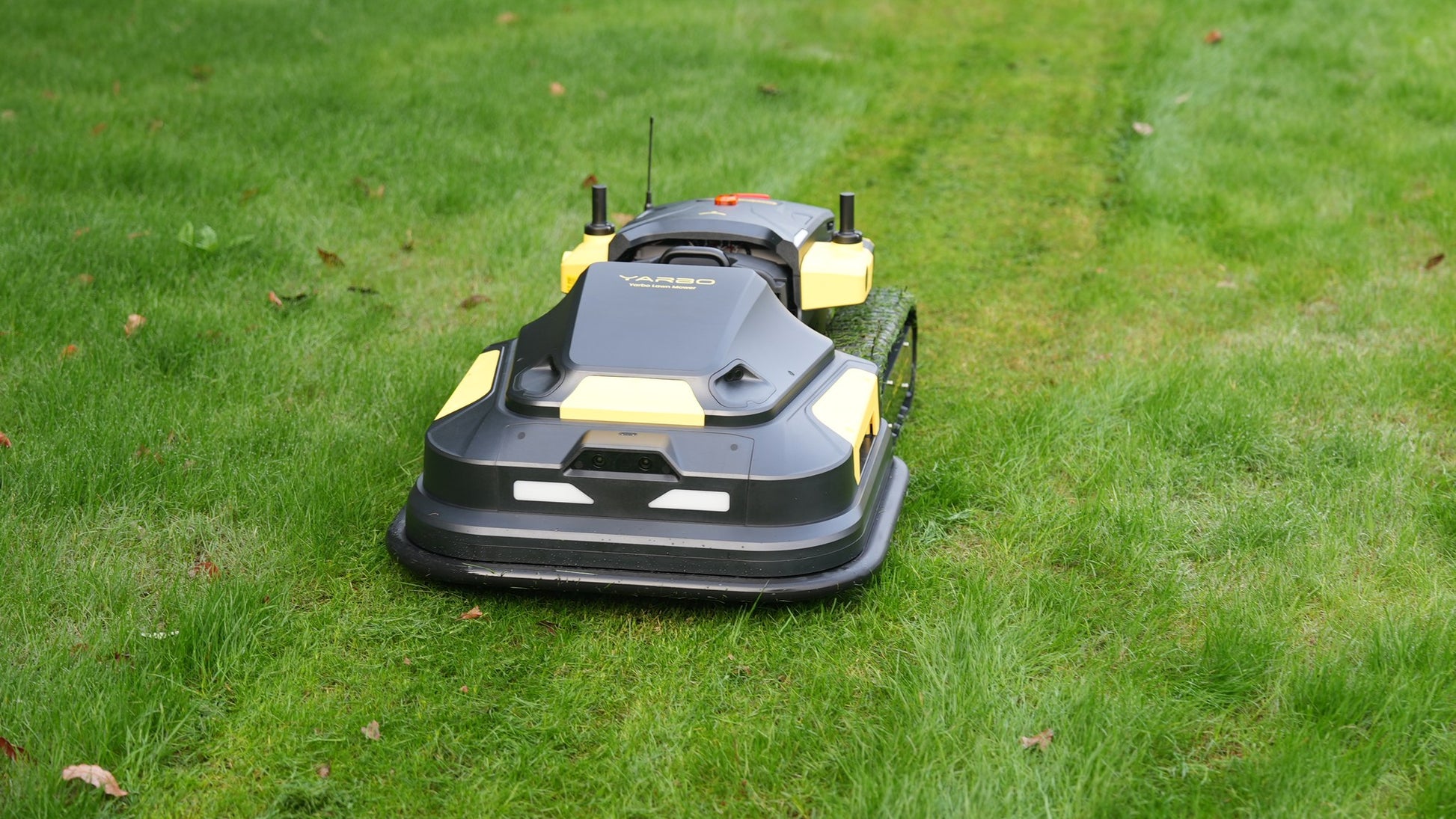 Yarbo Core with Lawn Mower module cutting grass, front three-quarter view