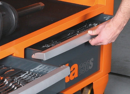 A hand pulling open a C30M drawer on ball-bearing slides, loaded with sockets and wrenches