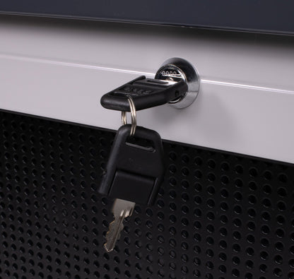Close-up of the C57SP shutter lock with keys fitted, against the perforated tool board