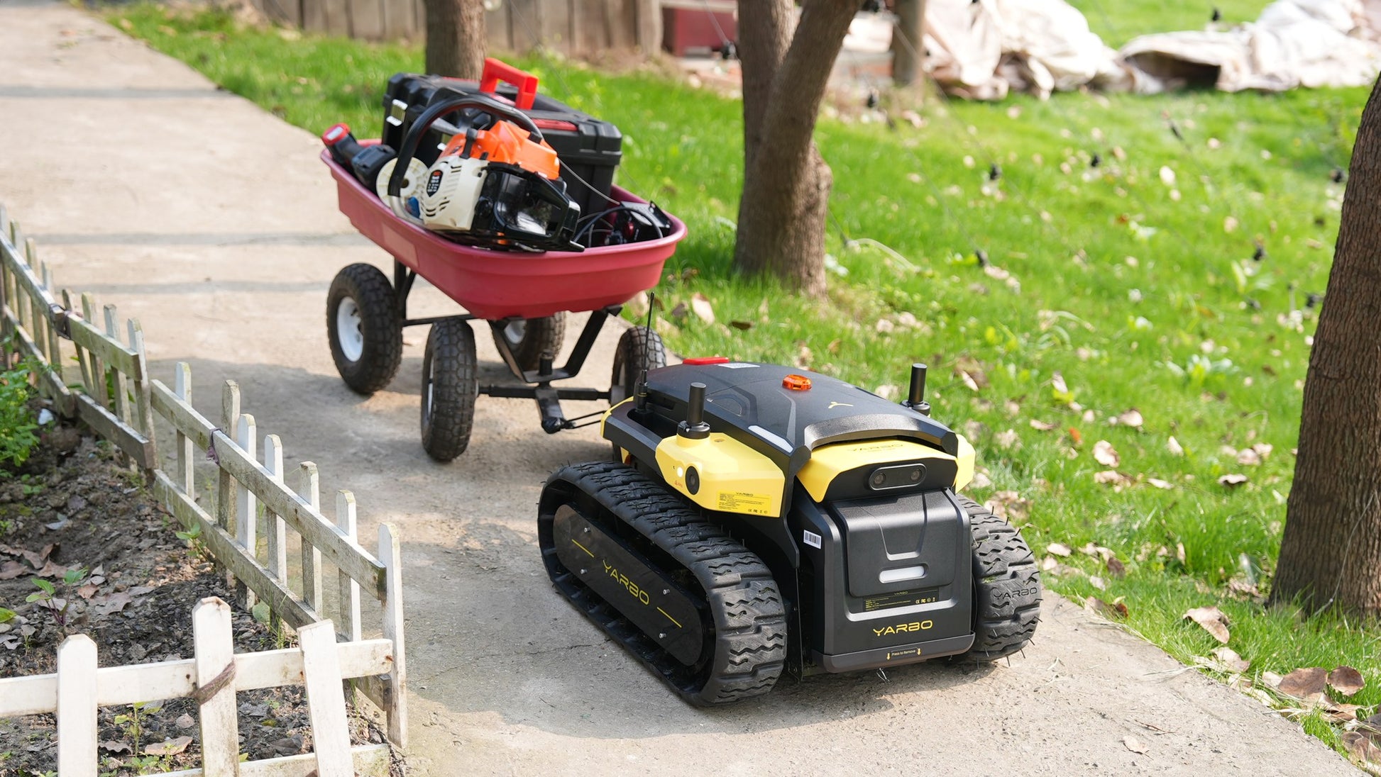 Yarbo Core towing a loaded garden wagon across grass