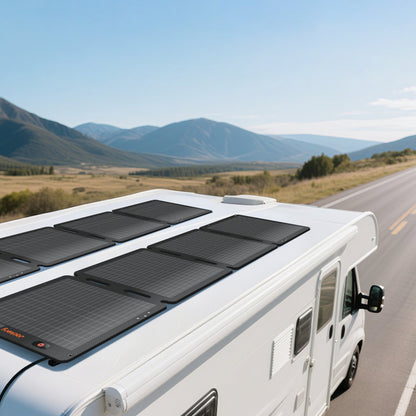 100W Air solar panel mounted flat on RV rooftop with mountain road scenery in background