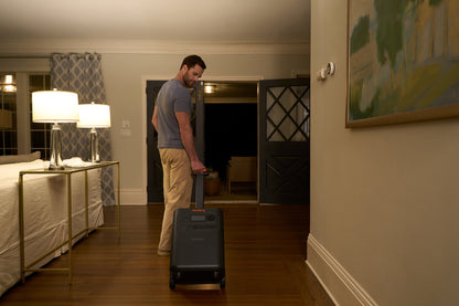 HomePower 3600 Plus being rolled on its wheels down a hallway at night