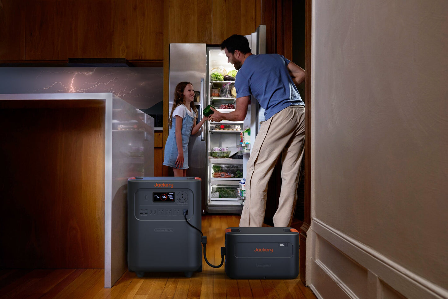 Father and daughter retrieving food from a fridge powered by HomePower 3600 Plus and Battery Pack during a storm, lightning visible through window