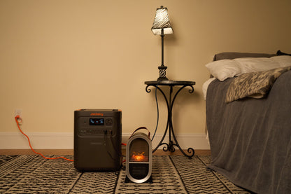 HomePower 3600 Plus in a bedroom powering an electric fireplace heater and table lamp at night