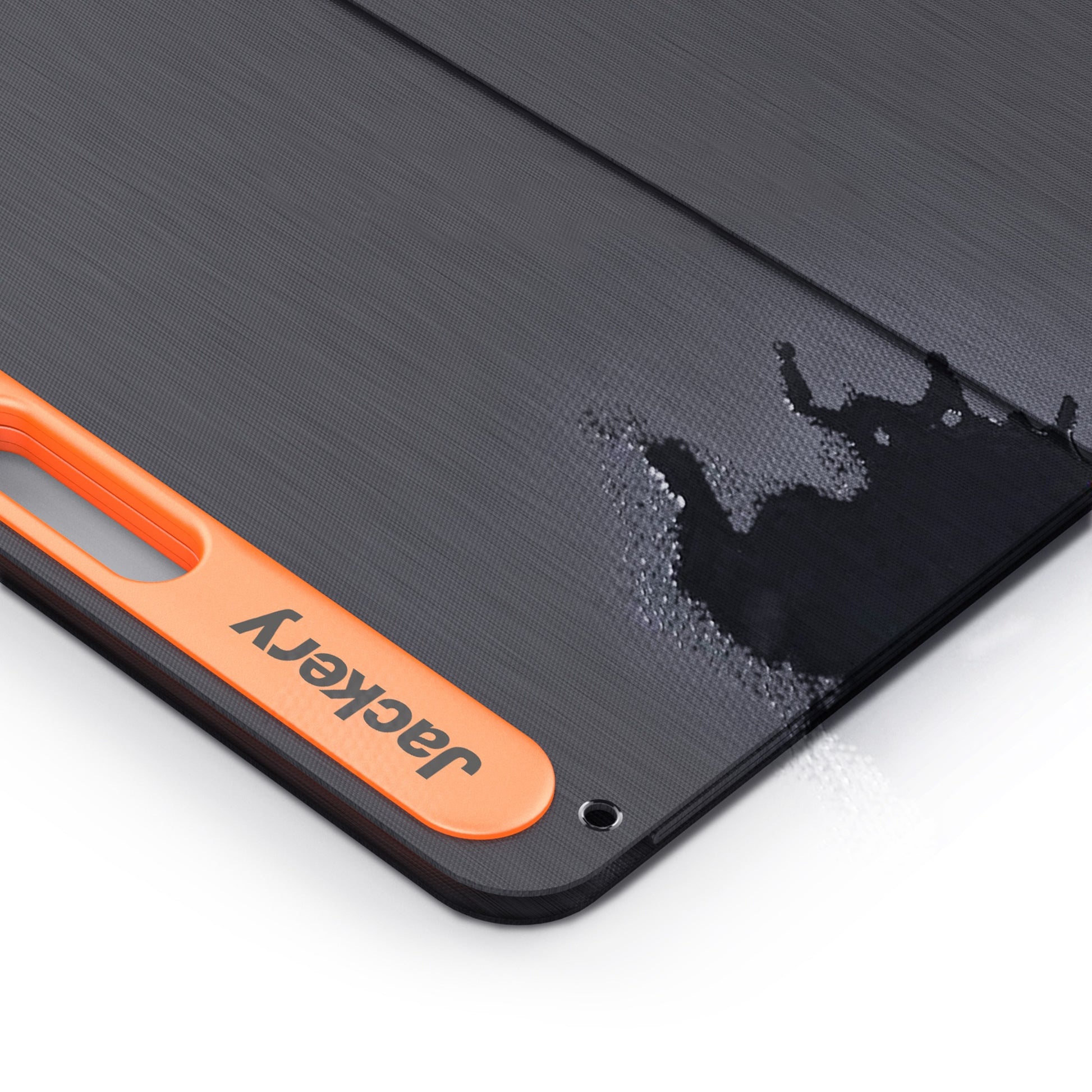 Close-up of the SolarSaga 200W panel corner with water beading on the fabric surface