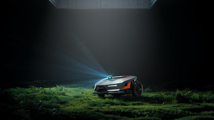 Sunseeker X4 lit at dusk on a lawn with its LED headlight on